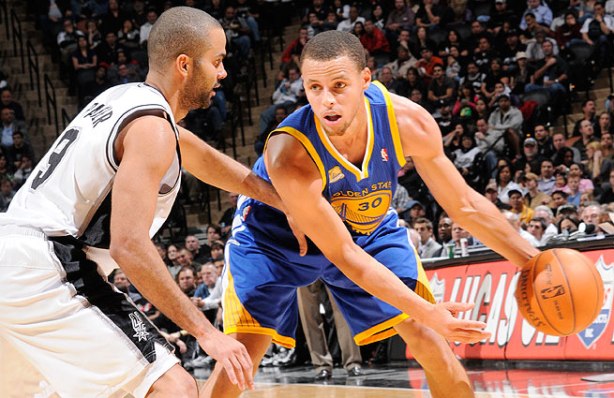Steph Curry try's to dribble pass Tony Parker